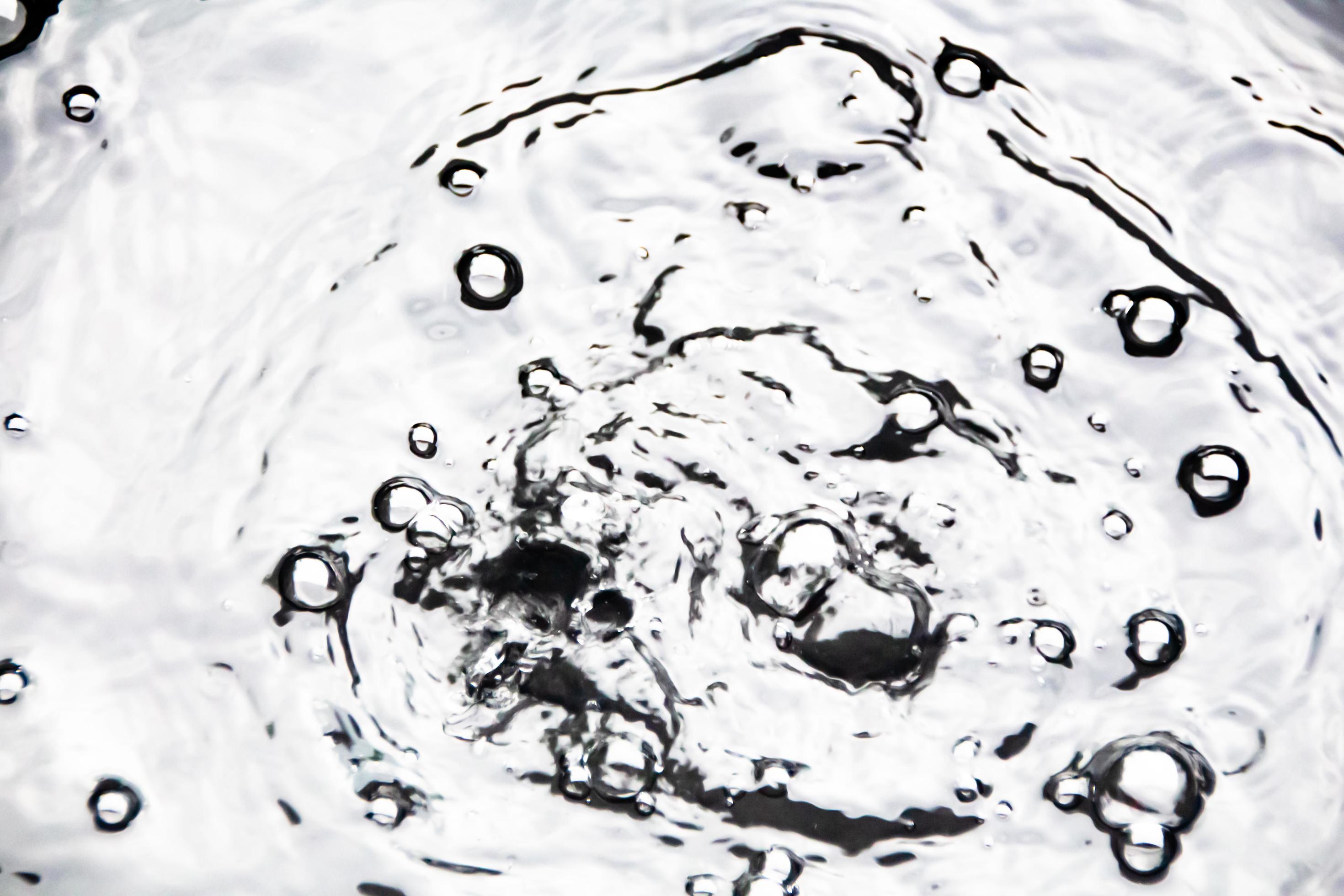 Water droplets or water beads fall on the water surface causing the