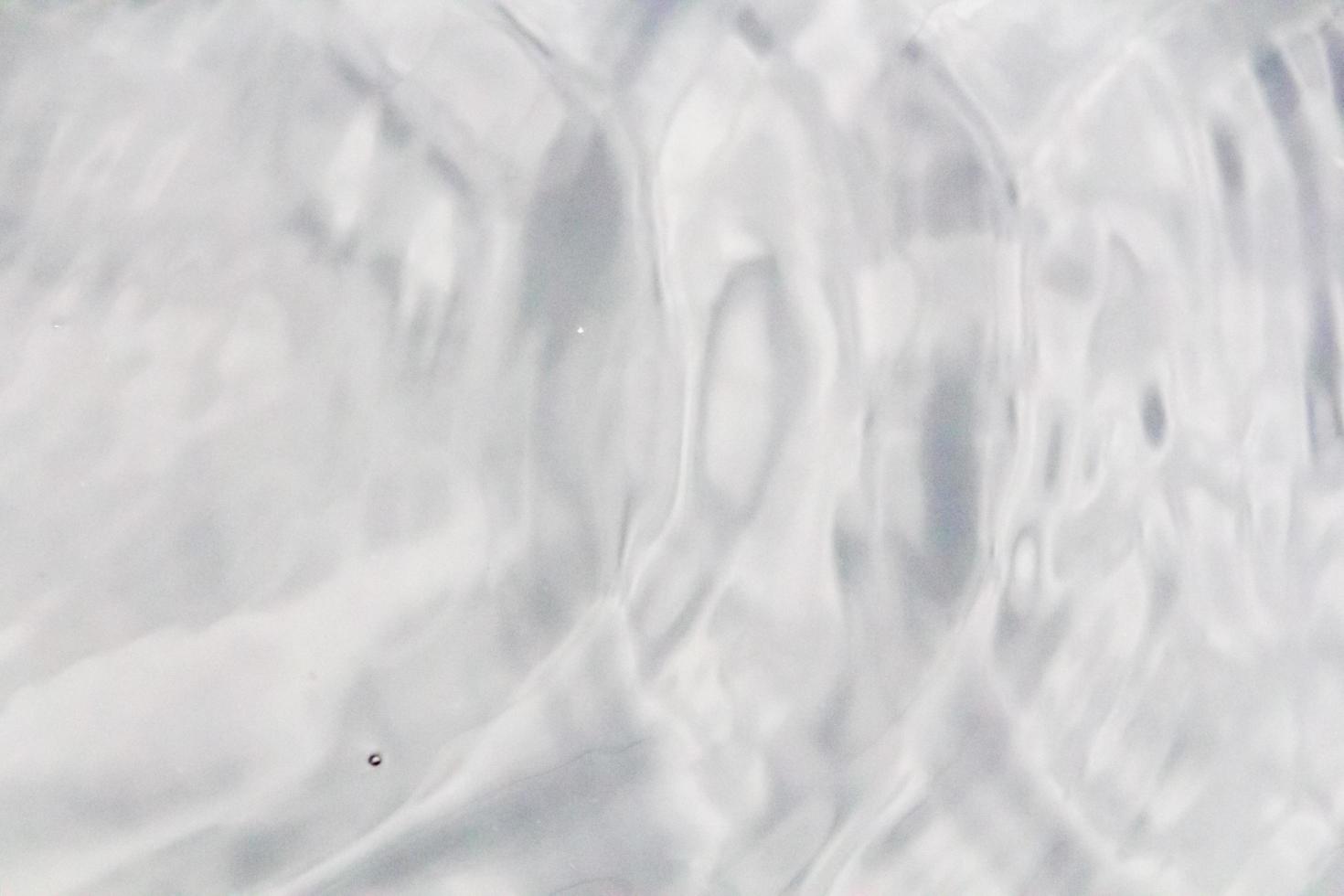 Water droplets or water beads fall on the water surface causing the water surface to disperse and foam. photo