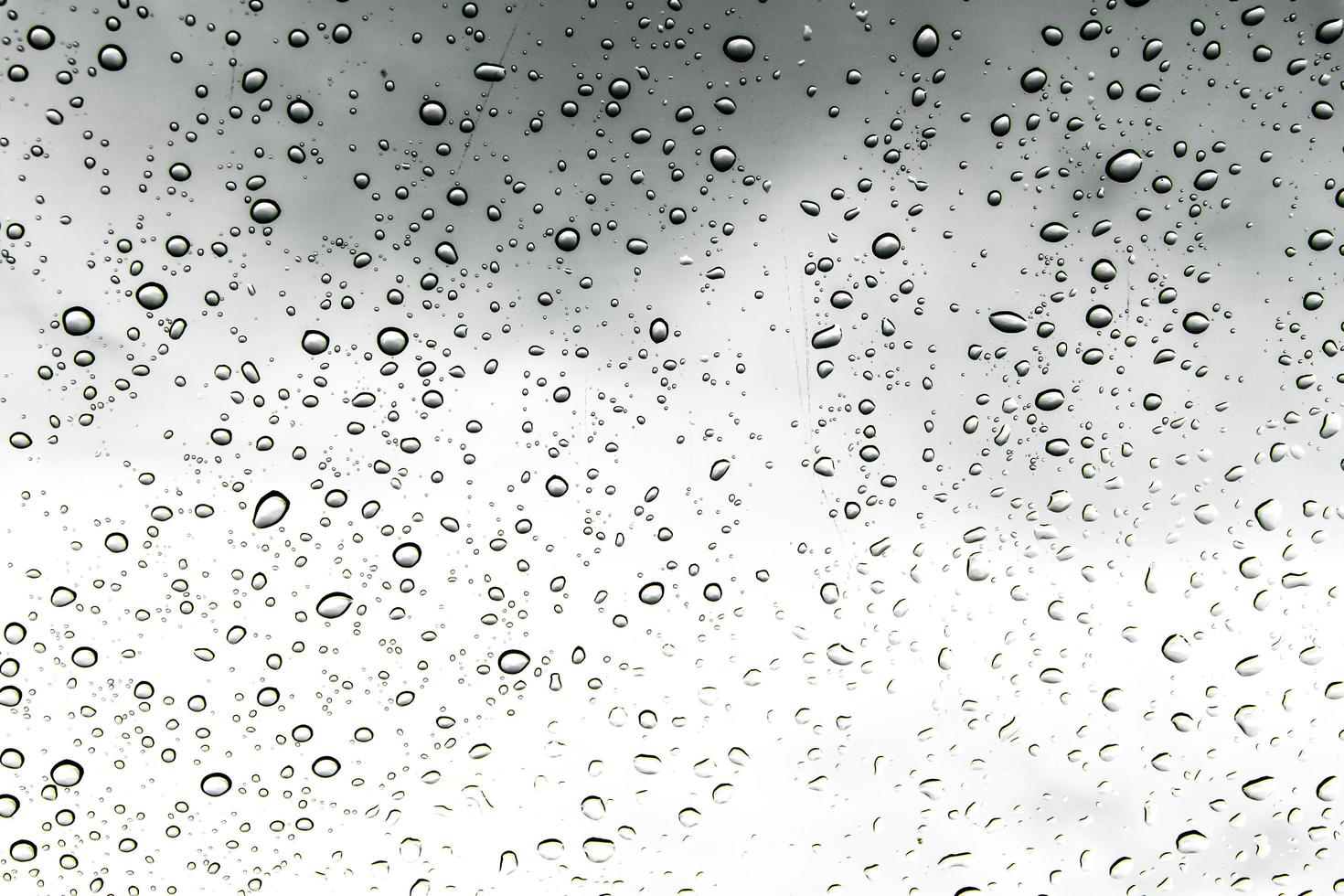 Drops of water and water beads on clear glass. photo