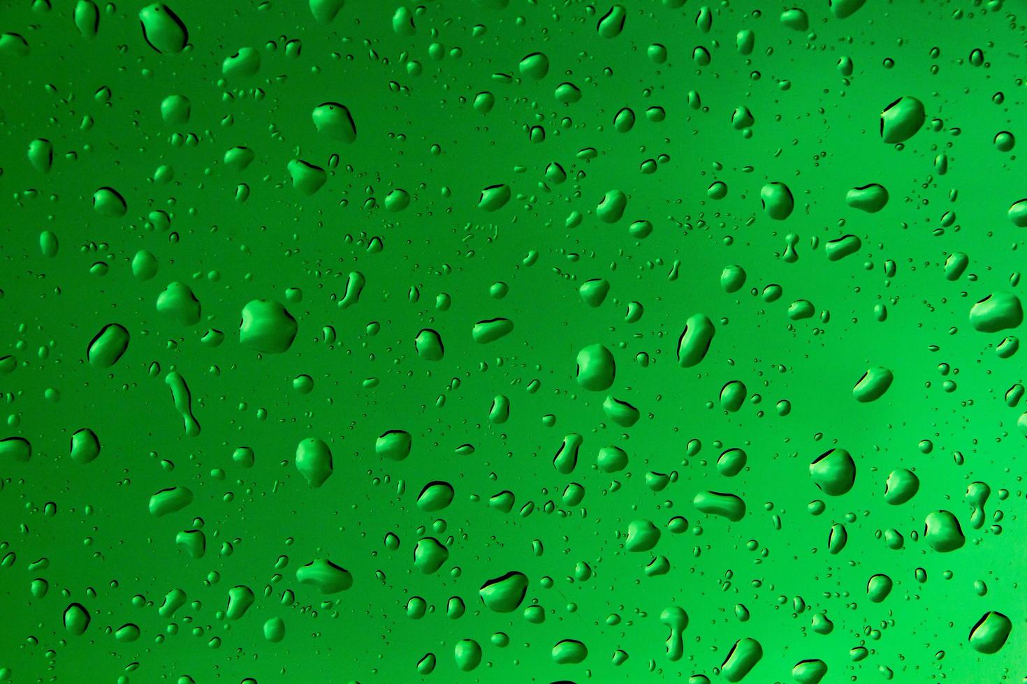 Drops of water and water beads on clear glass. photo