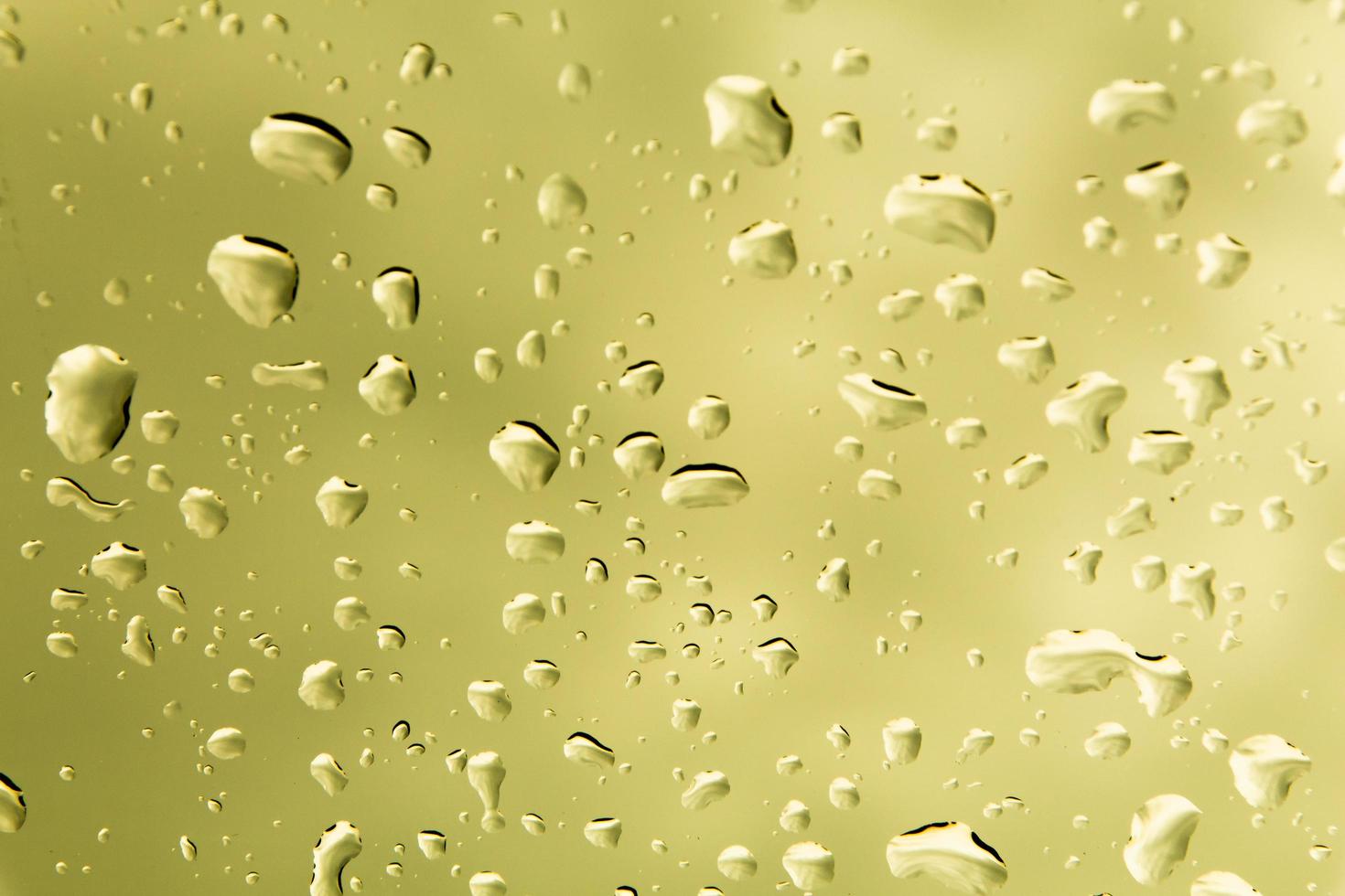 Drops of water and water beads on clear glass. photo