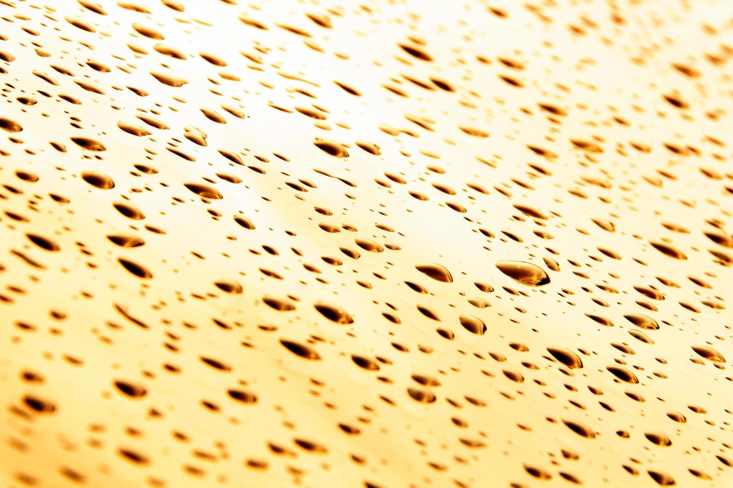Drops of water and water beads on clear glass. photo