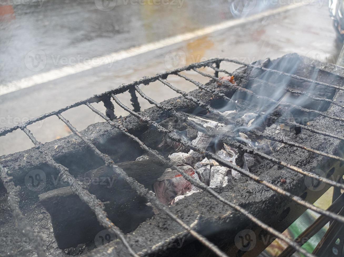 The Flaming Charcoal Grill smoked. Close Up, Front View. photo