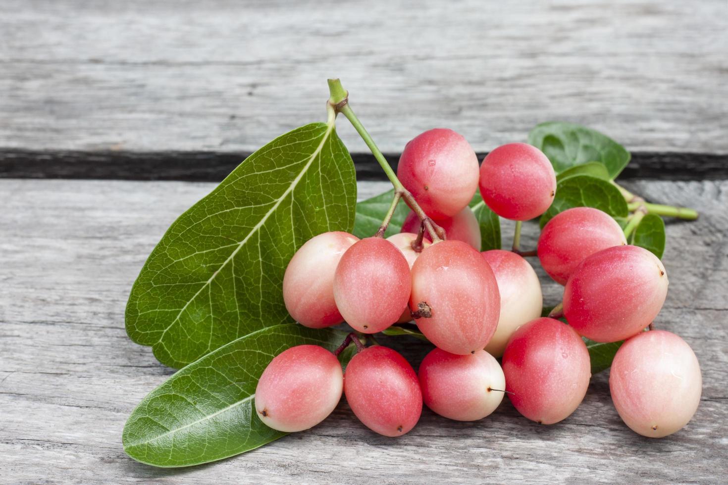 Karanda, Carunda or Christ's thorn fruits with leaf on vintage wooden table  background. photo