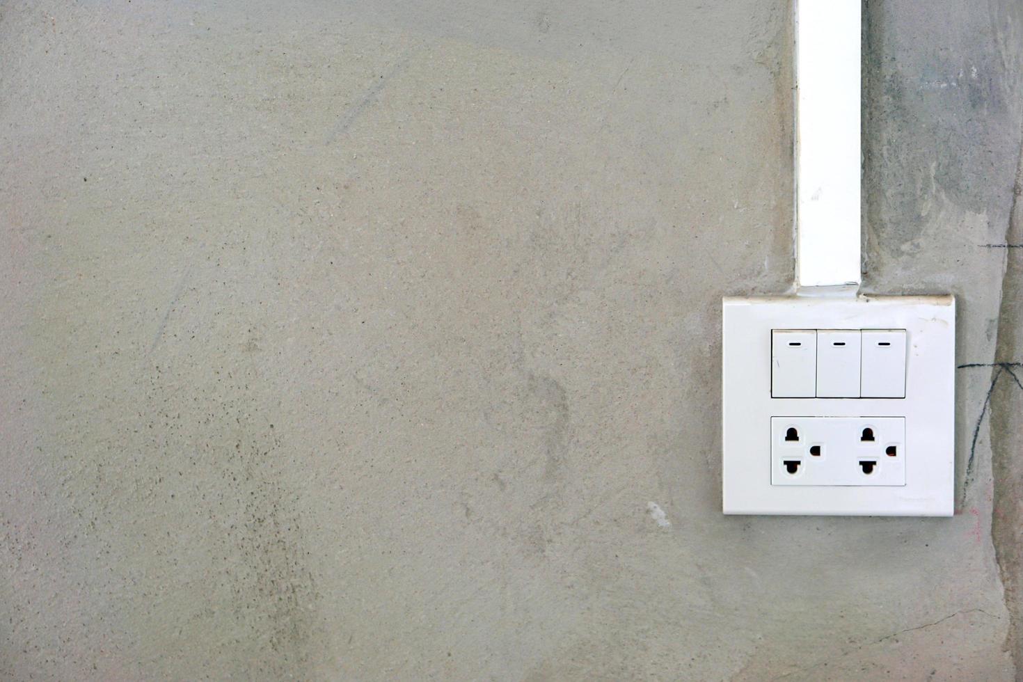 Closeup new electric plug on mortar wall background with space for texts. photo