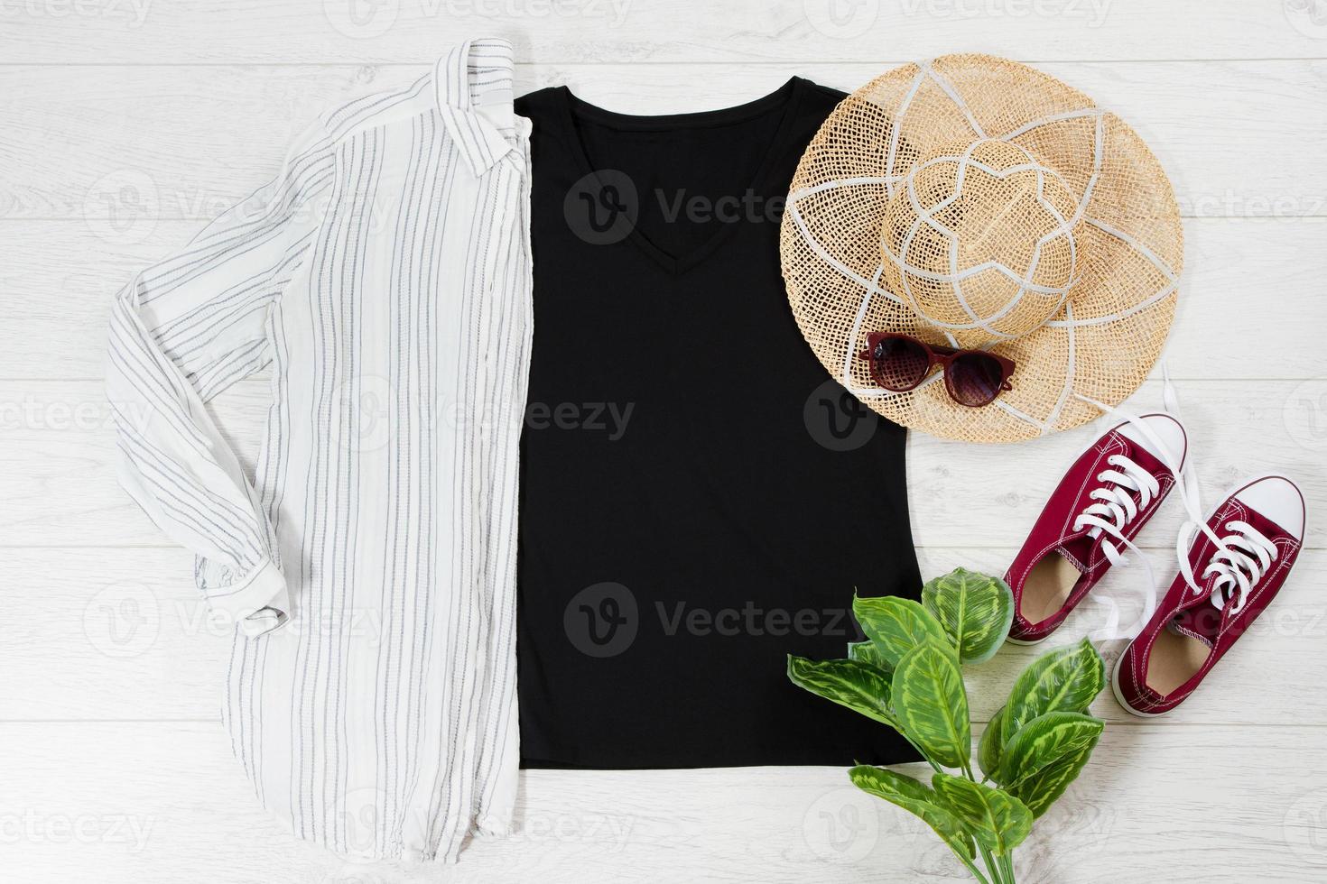 Black closeup t shirt mock up flat lay on white wooden background. Top view and copy space. Mockup t-shirt and summertime. Template blank shirt. photo