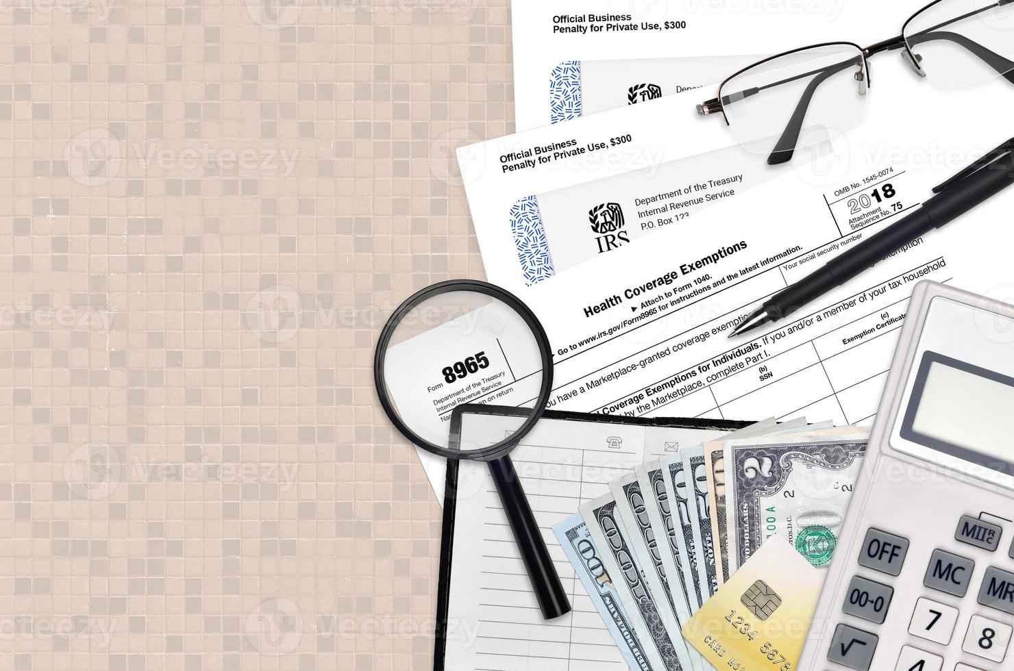 IRS form 8965 Health Coverage Exemptions lies on flat lay office table and ready to fill. U.S. Internal revenue services paperwork concept. Time to pay taxes in United States photo