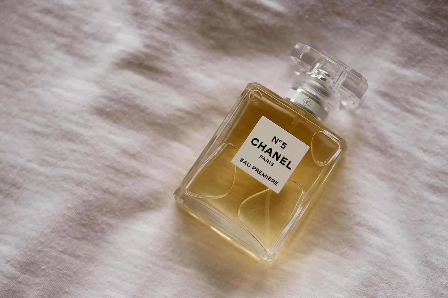 TERNOPIL, UKRAINE - SEPTEMBER 2, 2022 Chanel Number 5 Eau Premiere worldwide famous french perfume bottle on old white drapery photo