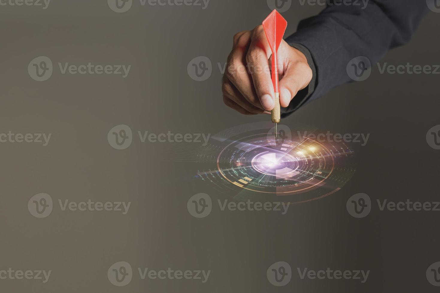 one dart hit it's target on a red background, concept for success, photo