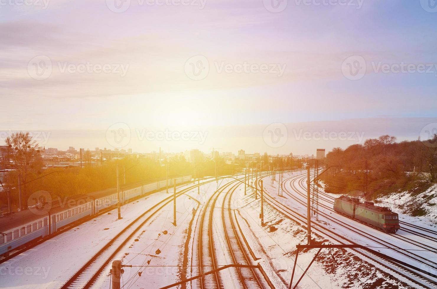 Winter landscape with a railway train against a cloudy sky background photo