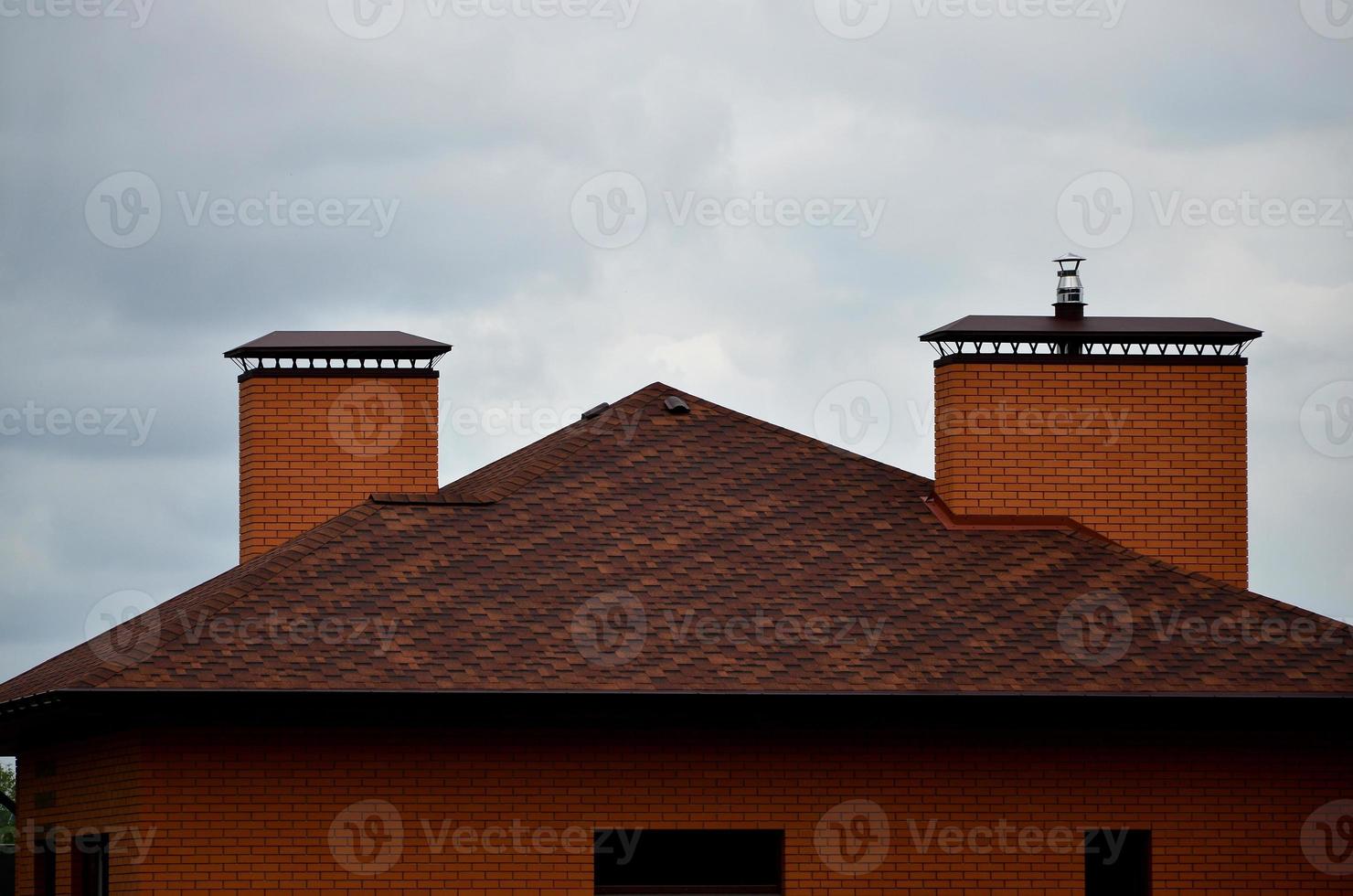 The house is equipped with high-quality roofing of shingles bitumen tiles. A good example of perfect roofing. The roof is reliably protected from adverse weather conditions photo
