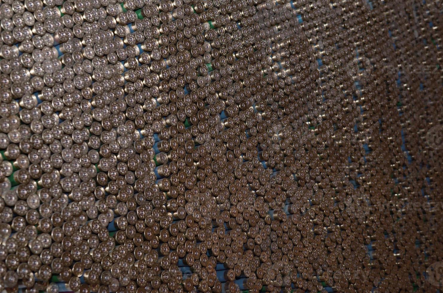 Pattern of 12 gauge cartridges for shotgun bullets. Shells for hunting rifle close up. Backdrop for shooting range or ammunition trade concepts photo