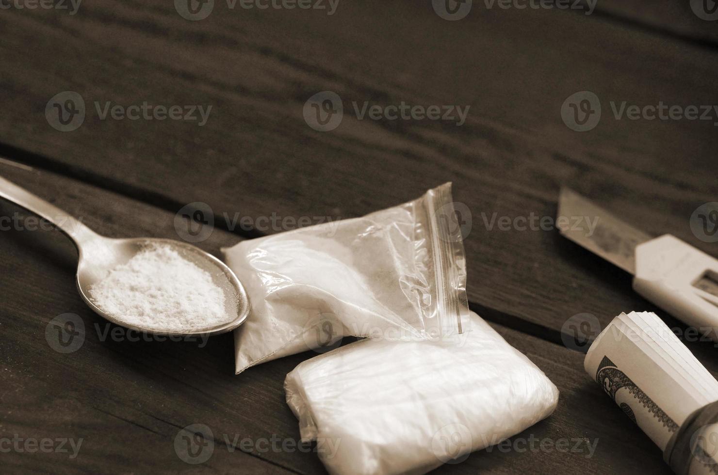 Lighter and spoon full of white powder on wooden background. Heroin drug addiction concept photo