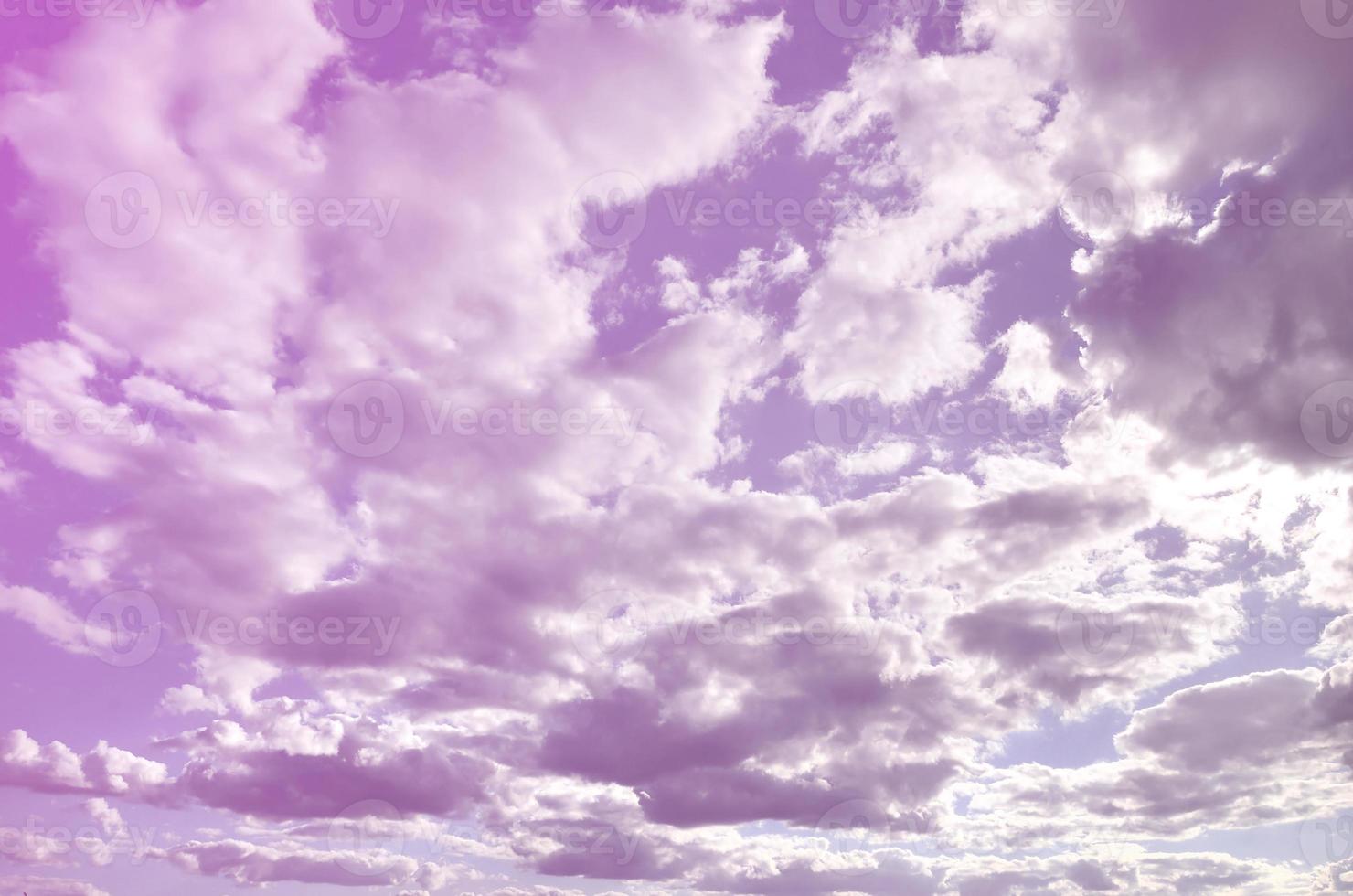 A blue cloudy sky with many small clouds blocking the sun photo