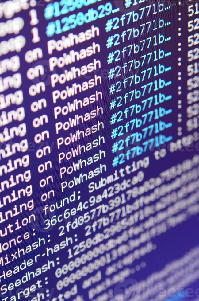Macro snapshot of the program interface for crypto currency mining on the monitor of an office computer. The concept of mining bitcoins. The flow of information strings and data photo
