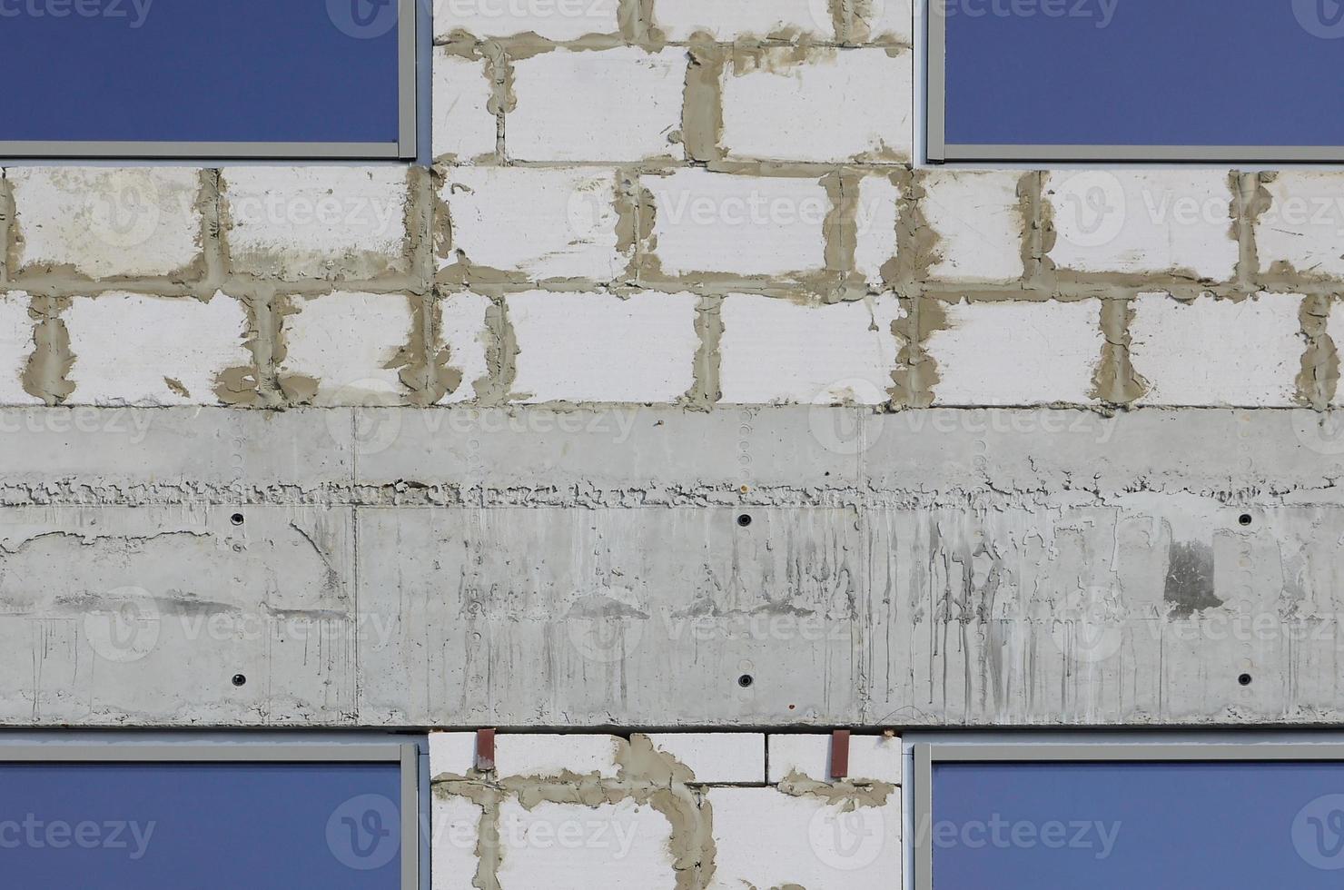 Fragment of an unfinished structure of a multi-storey building made of large concrete bricks photo