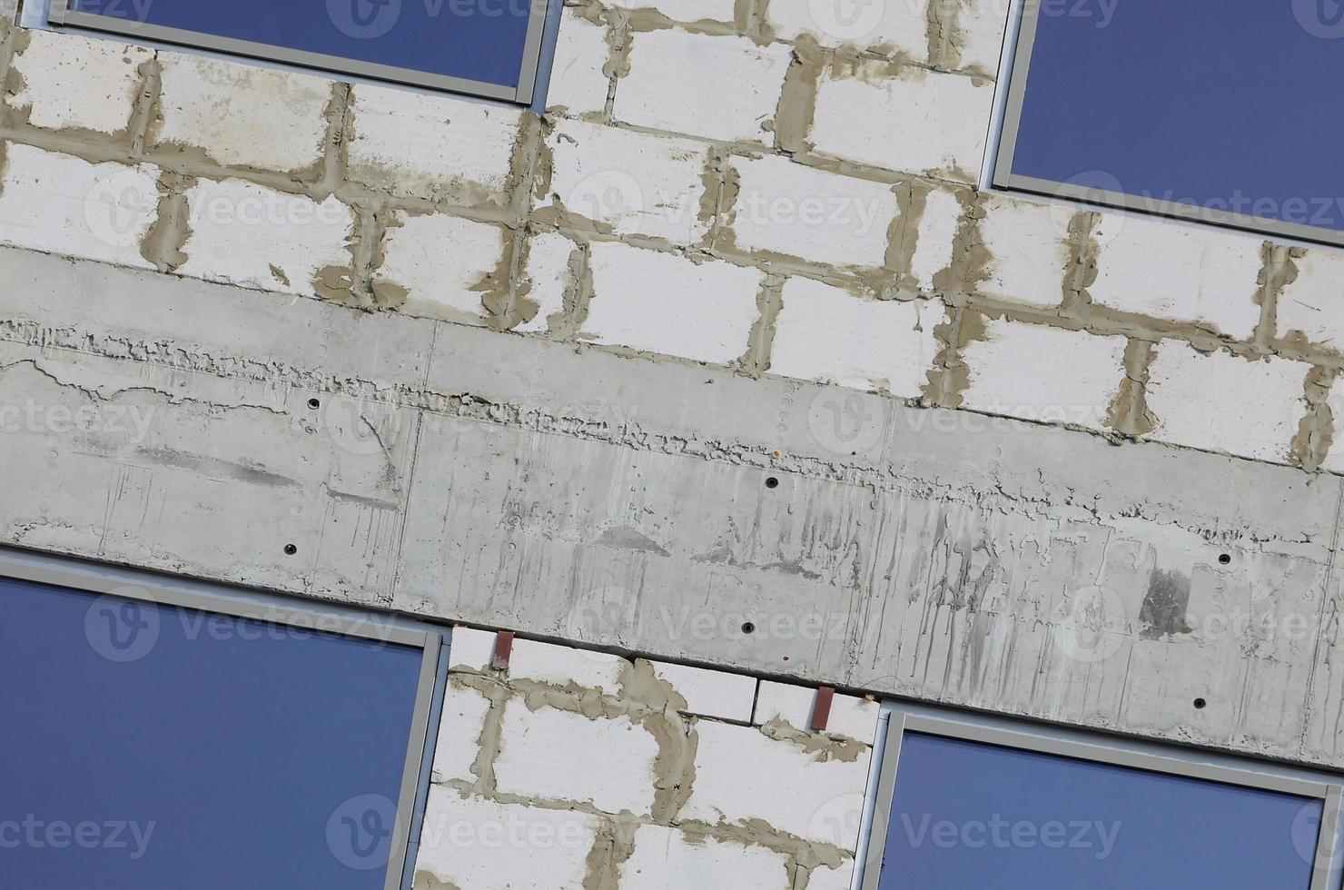 Fragment of an unfinished structure of a multi-storey building made of large concrete bricks photo