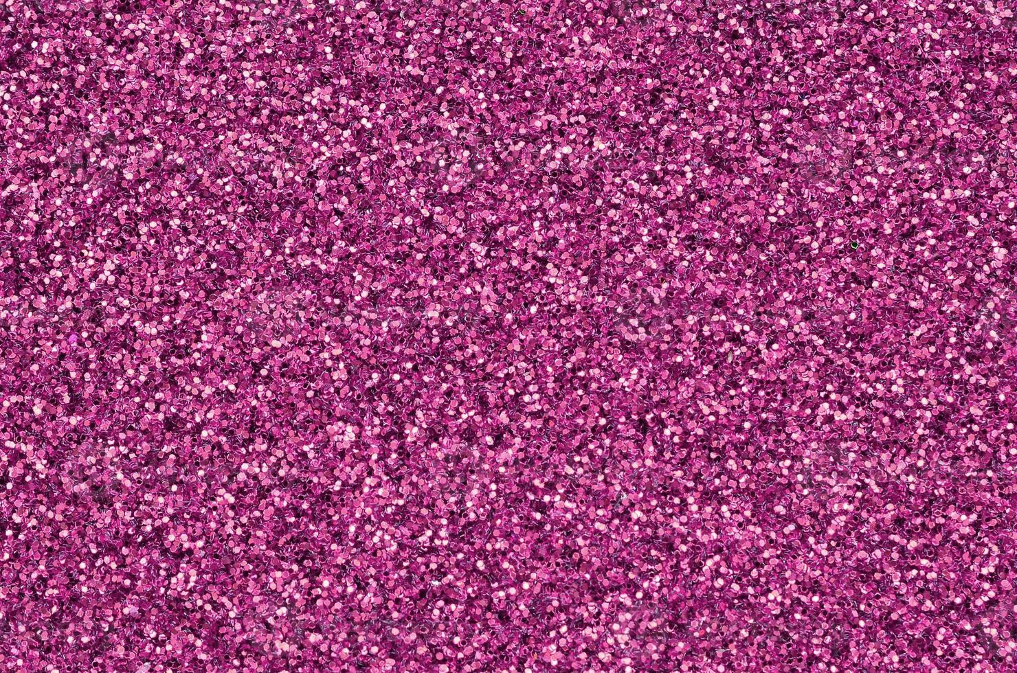 Pink decorative sequins. Background image with shiny bokeh lights from small elements photo