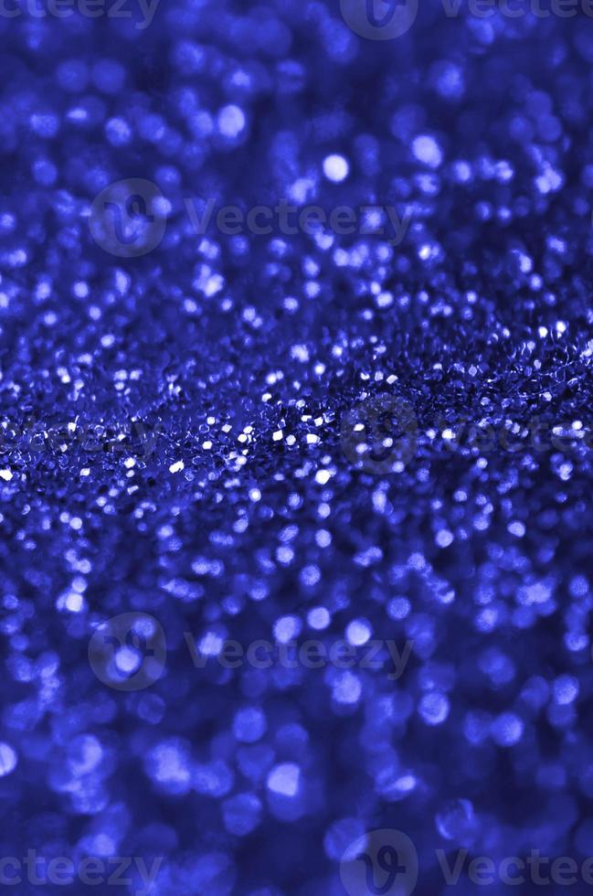 Blue decorative sequins. Background image with shiny bokeh lights from small elements photo