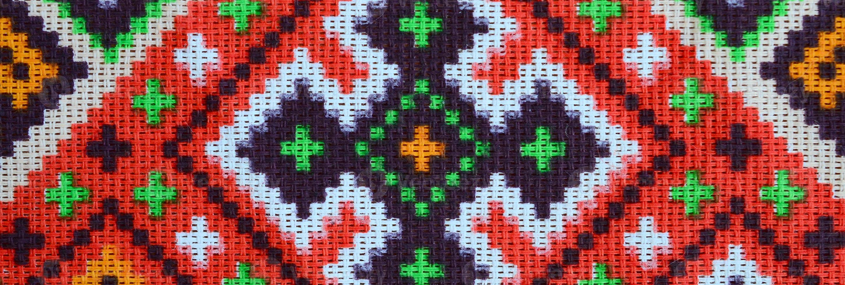 Traditional Ukrainian folk art knitted embroidery pattern on textile fabric photo