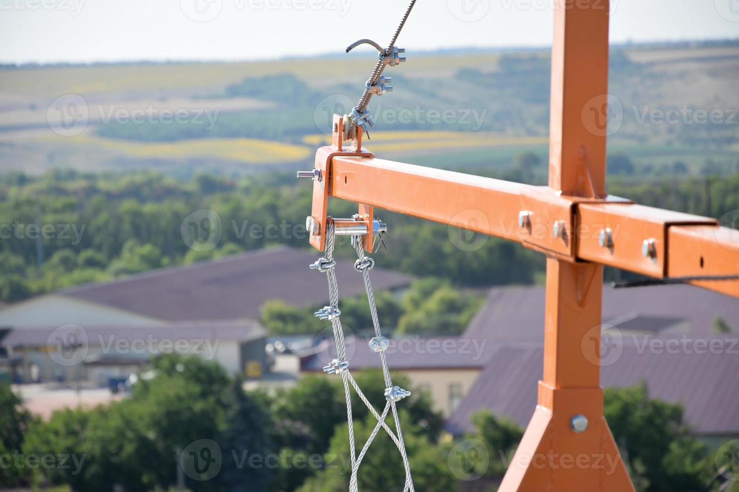 Rope lockers in ending of front beam of suspended wire rope platform for facade works on high multistorey buildings. Rope lockers blocks kink for safety platform usage photo