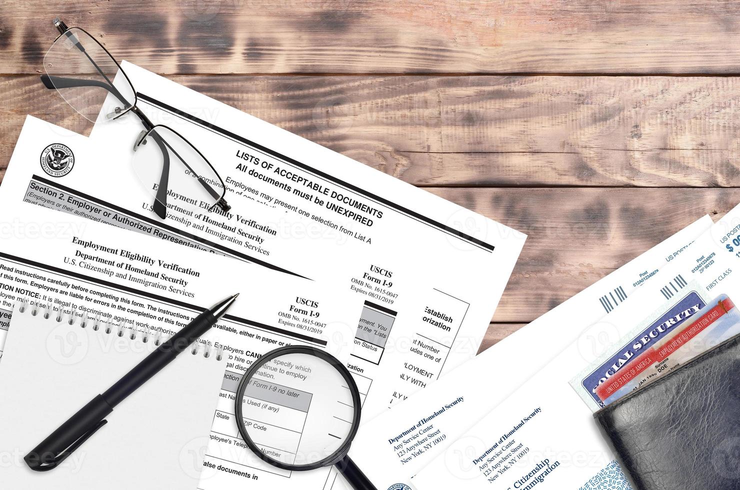 USCIS form I-9 Employment eligibility verification lies on flat lay office table and ready to fill. U.S. Citizenship and Immigration services paperwork concept photo