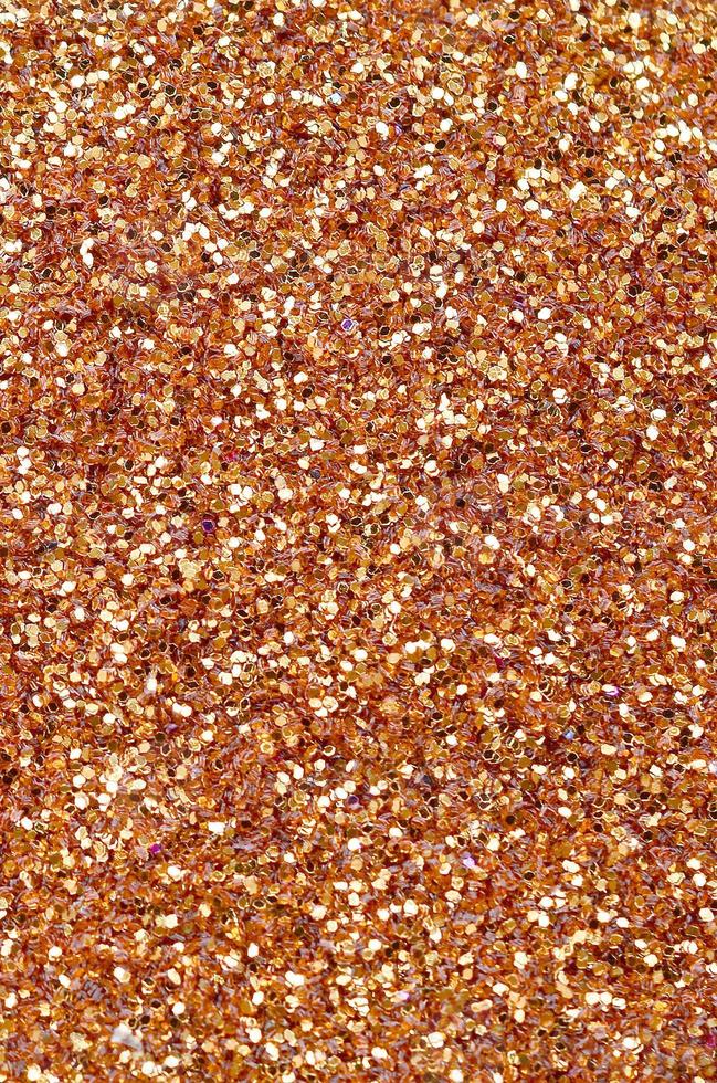 Orange decorative sequins. Background image with shiny bokeh lights from small elements photo