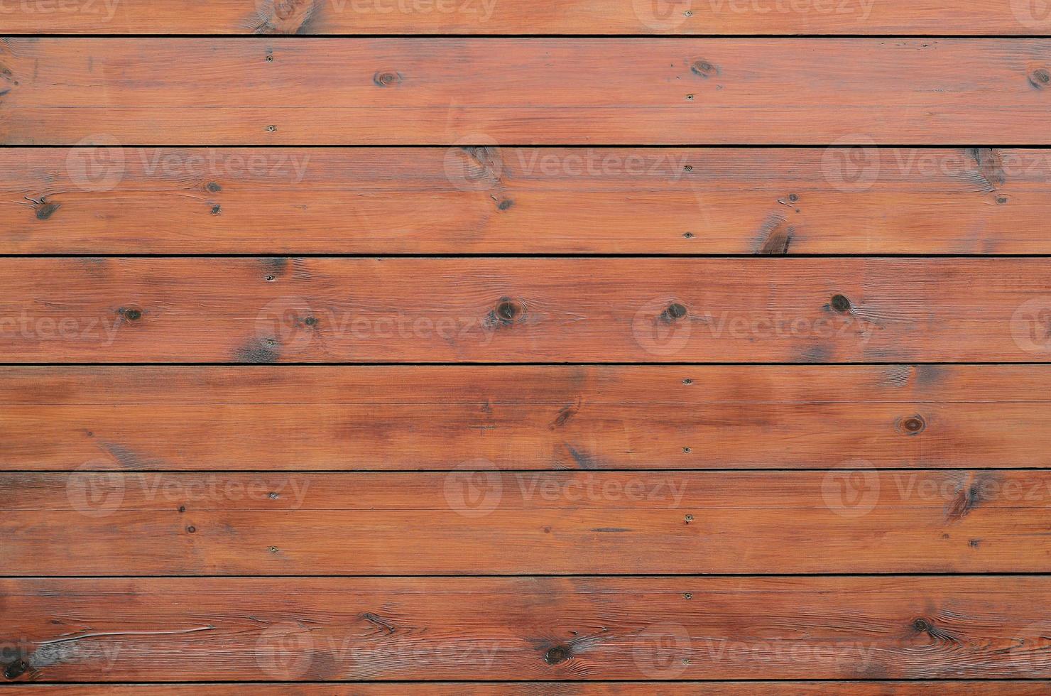 Varnished wood background from cabin exterior. Brown wood barn plank photo
