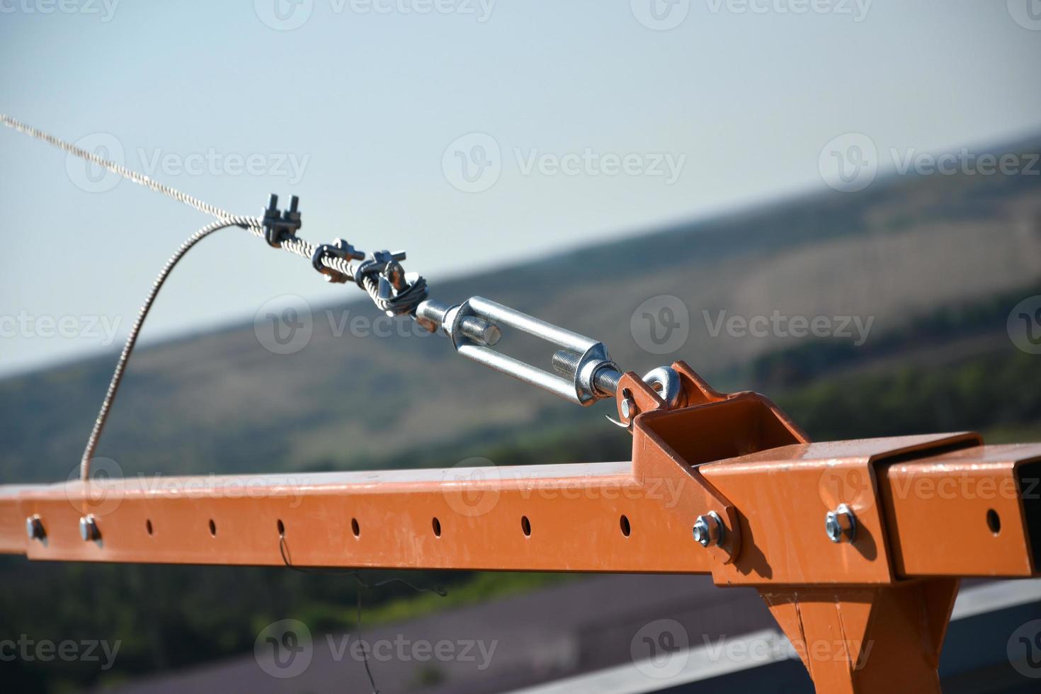 Rope lockers in rear beam of suspended wire rope platform for facade works on high multistorey buildings. Rope lockers blocks kink for safety platform usage photo