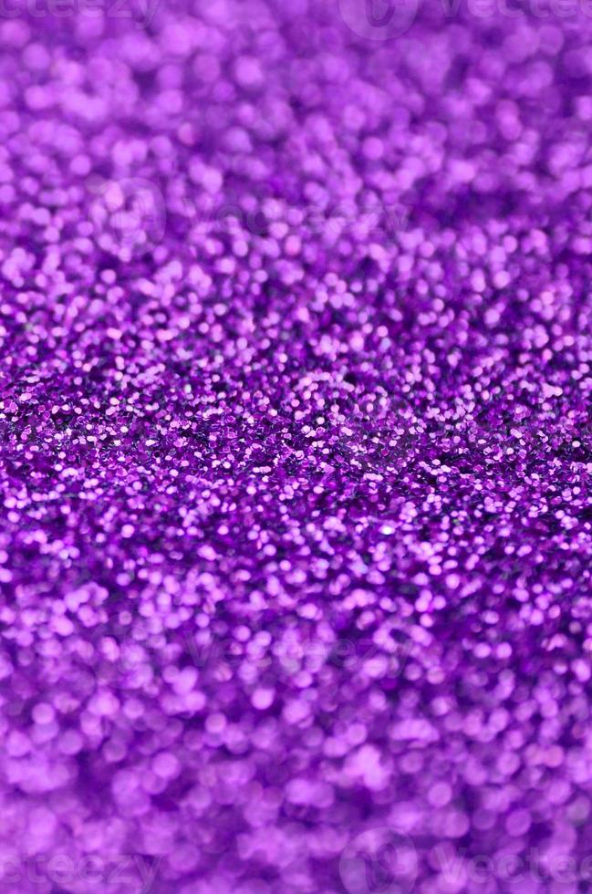 Purple decorative sequins. Background image with shiny bokeh lights from small elements photo