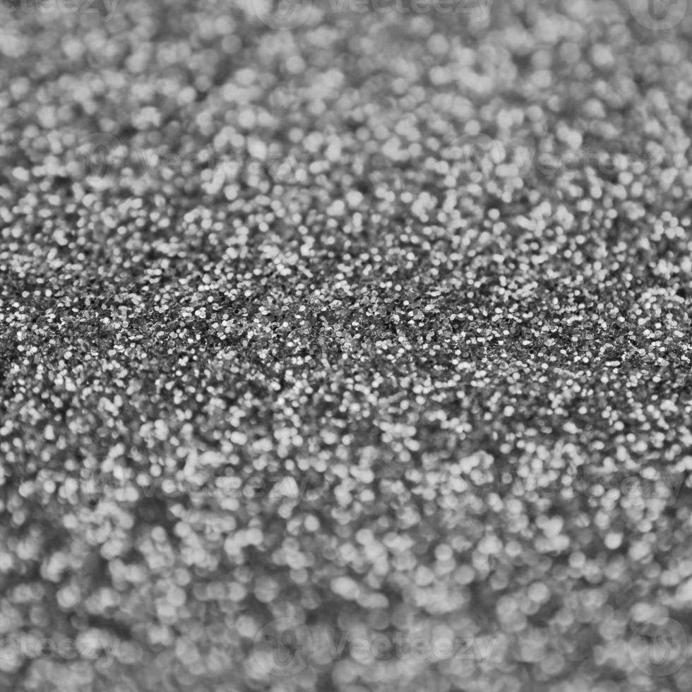 Silver decorative sequins. Background image with shiny bokeh lights from small elements photo