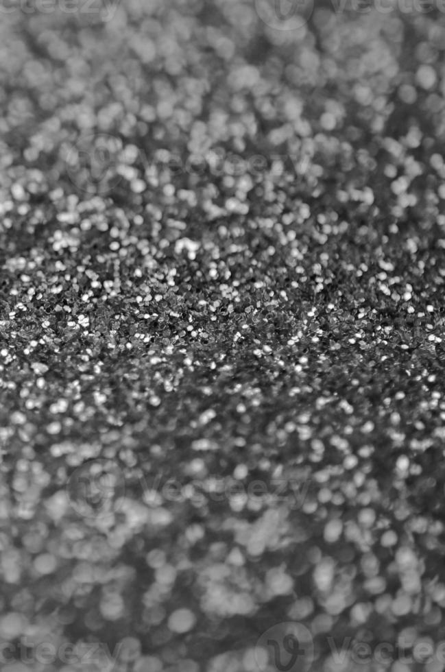 Silver decorative sequins. Background image with shiny bokeh lights from small elements photo