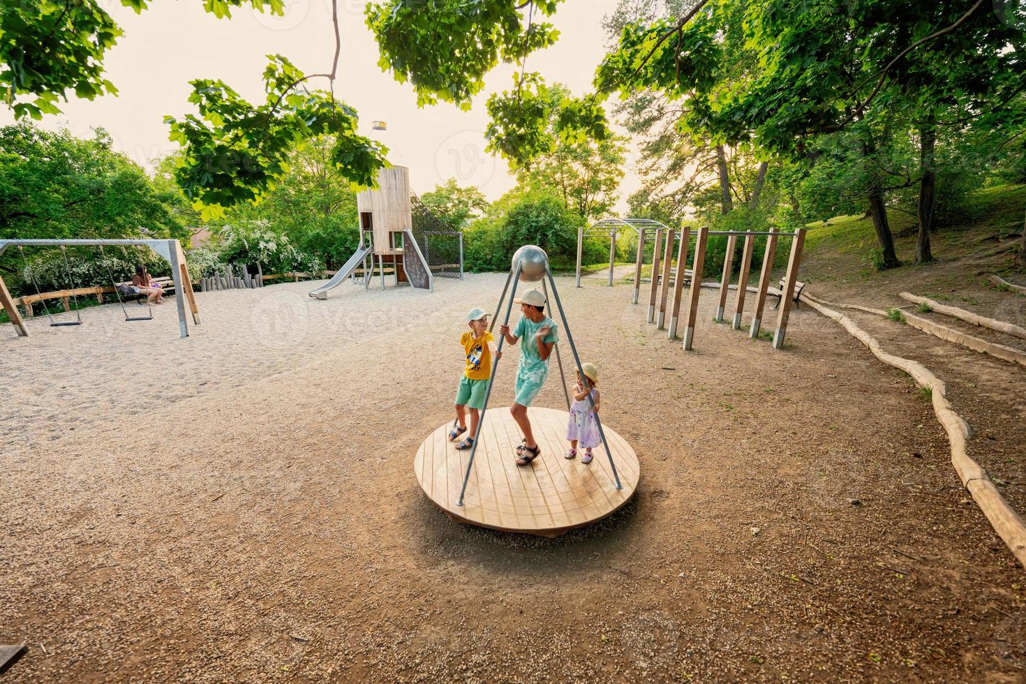 Three kids rides on the playground. Centrifuge, swing for children. photo