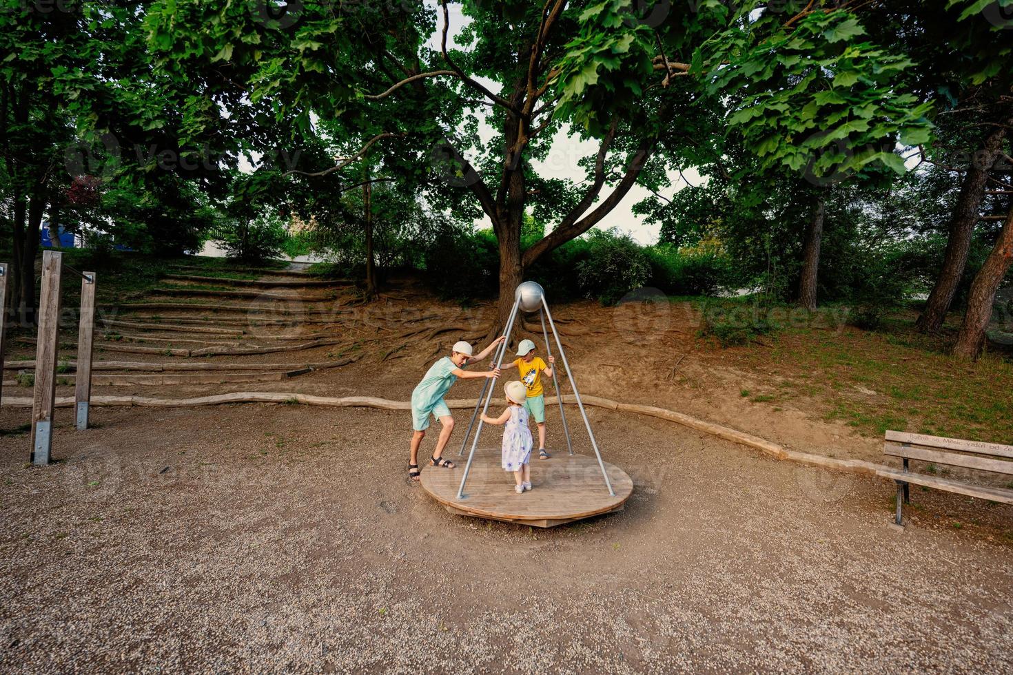 Three kids rides on the playground. Centrifuge, swing for children. photo