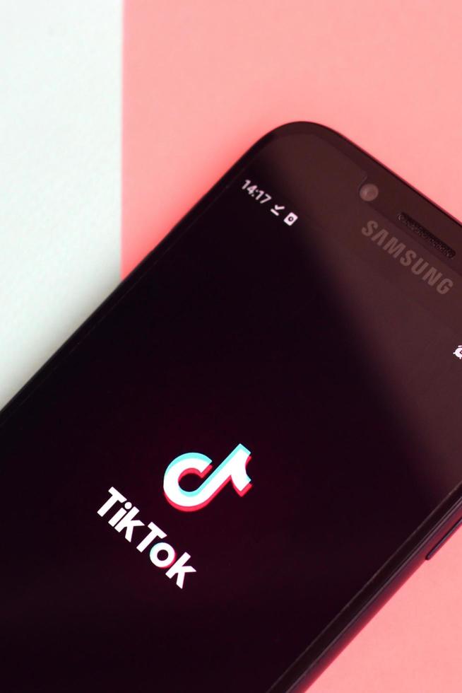 kharkov, ucrania - 2 de julio de 2021 aplicación tiktok en la pantalla del teléfono inteligente samsung sobre fondo pastel. tiktok es un popular servicio de redes sociales para compartir videos propiedad de bytedance foto