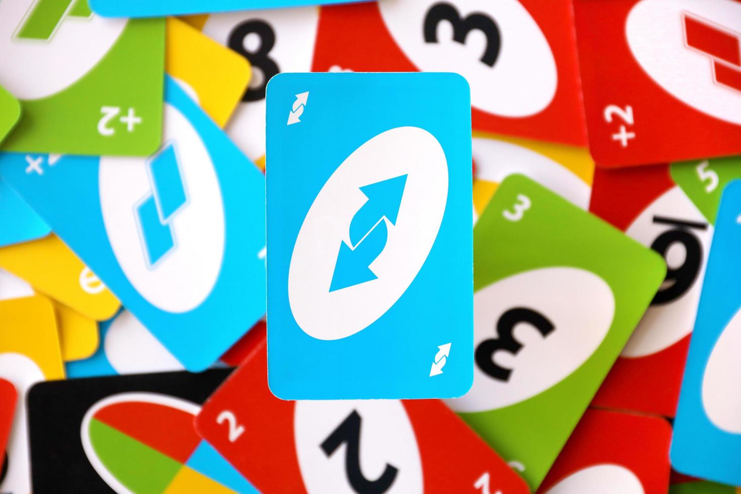 TERNOPIL, UKRAINE - MAY 15, 2022 Many colorful UNO game cards. UNO is an American shedding-type card game that is played with a specially printed deck photo