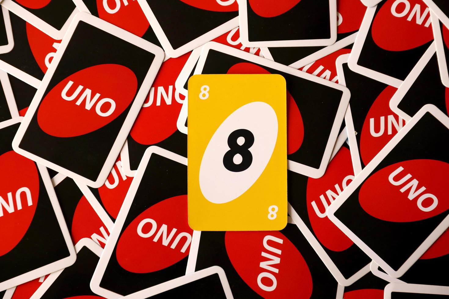 TERNOPIL, UKRAINE - MAY 15, 2022 Many colorful UNO game cards. UNO is an American shedding-type card game that is played with a specially printed deck photo
