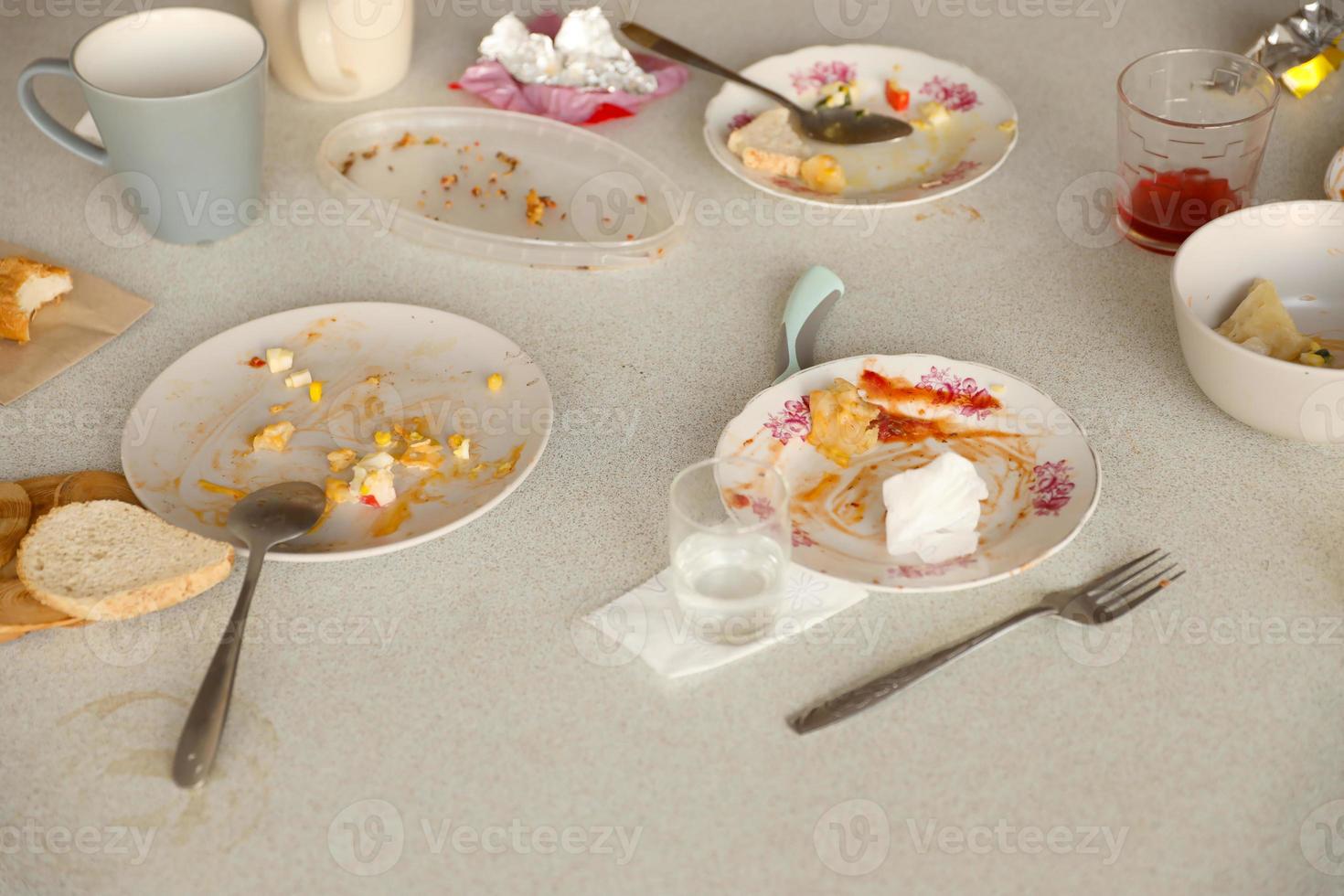 Empty dirty plates with spoons and forks on the table after meal. Banquet ending concept. Unwashed dishes photo