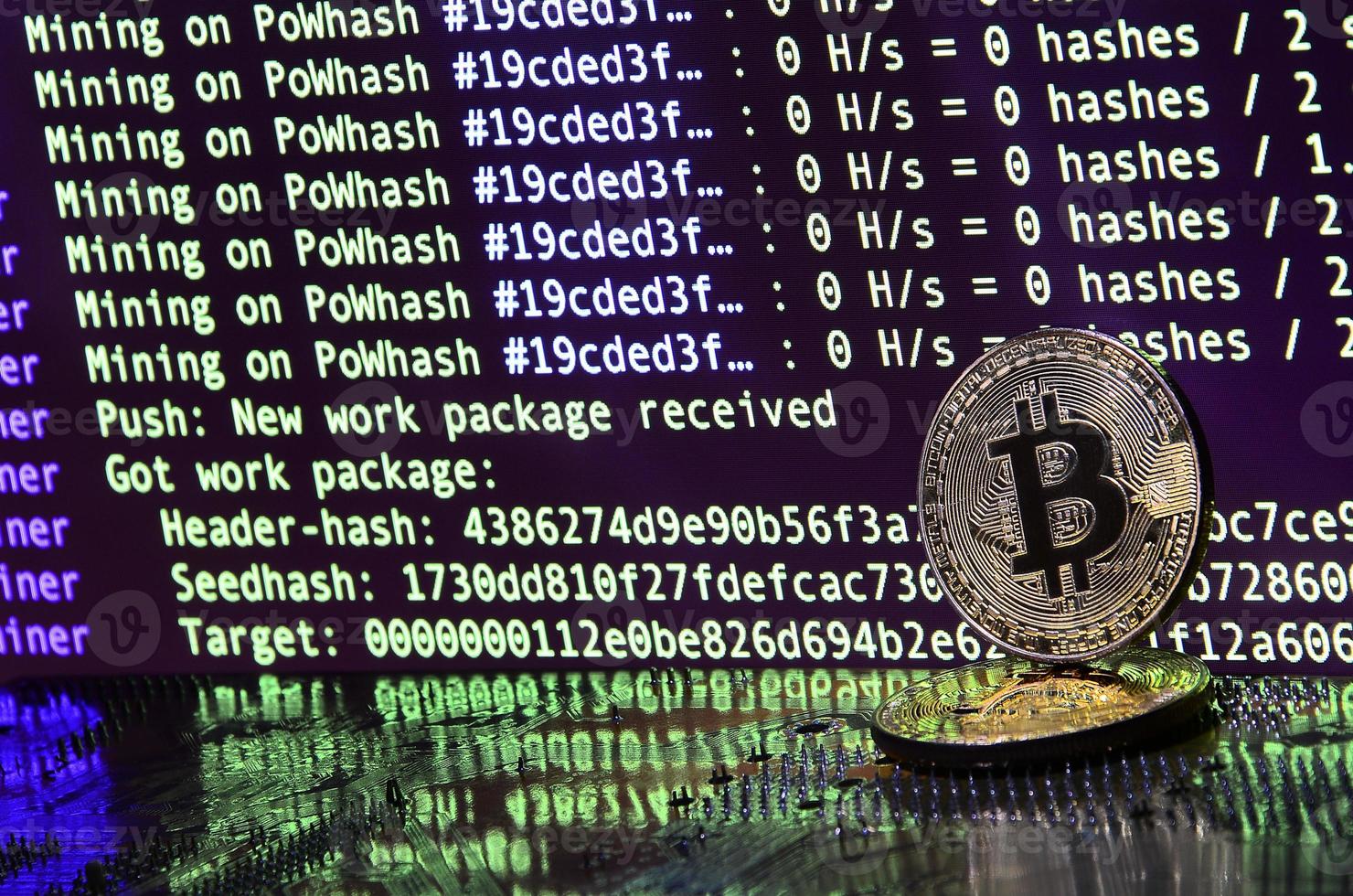 The digital process of cryptocurrency mining by using the GPUs. Bitcoins and video card on a working display and mining screen photo