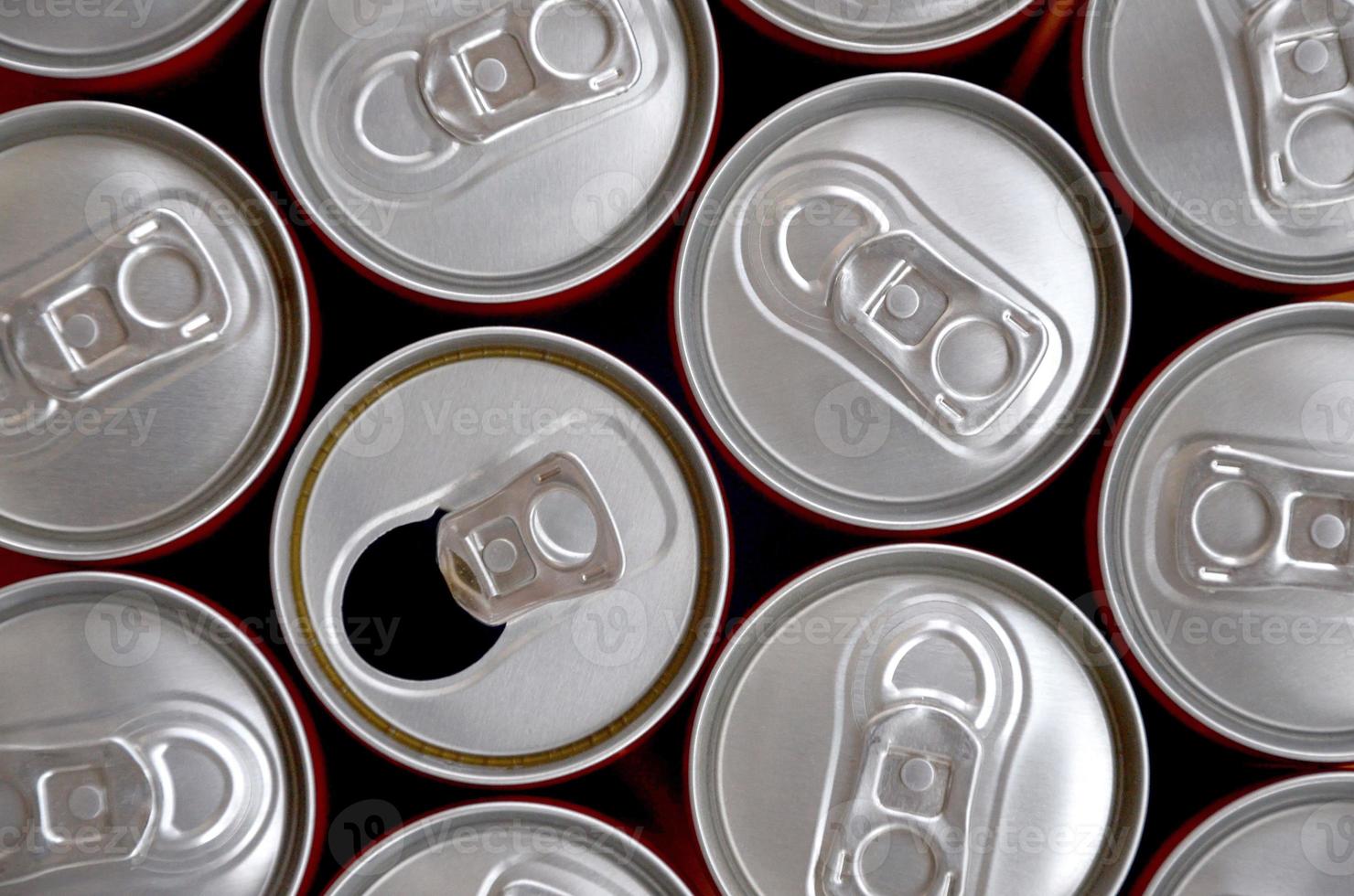 Many cans of soda soft drink or energy drink containers. A lot of recycled cans made from aluminum and being prepared for re-production. photo