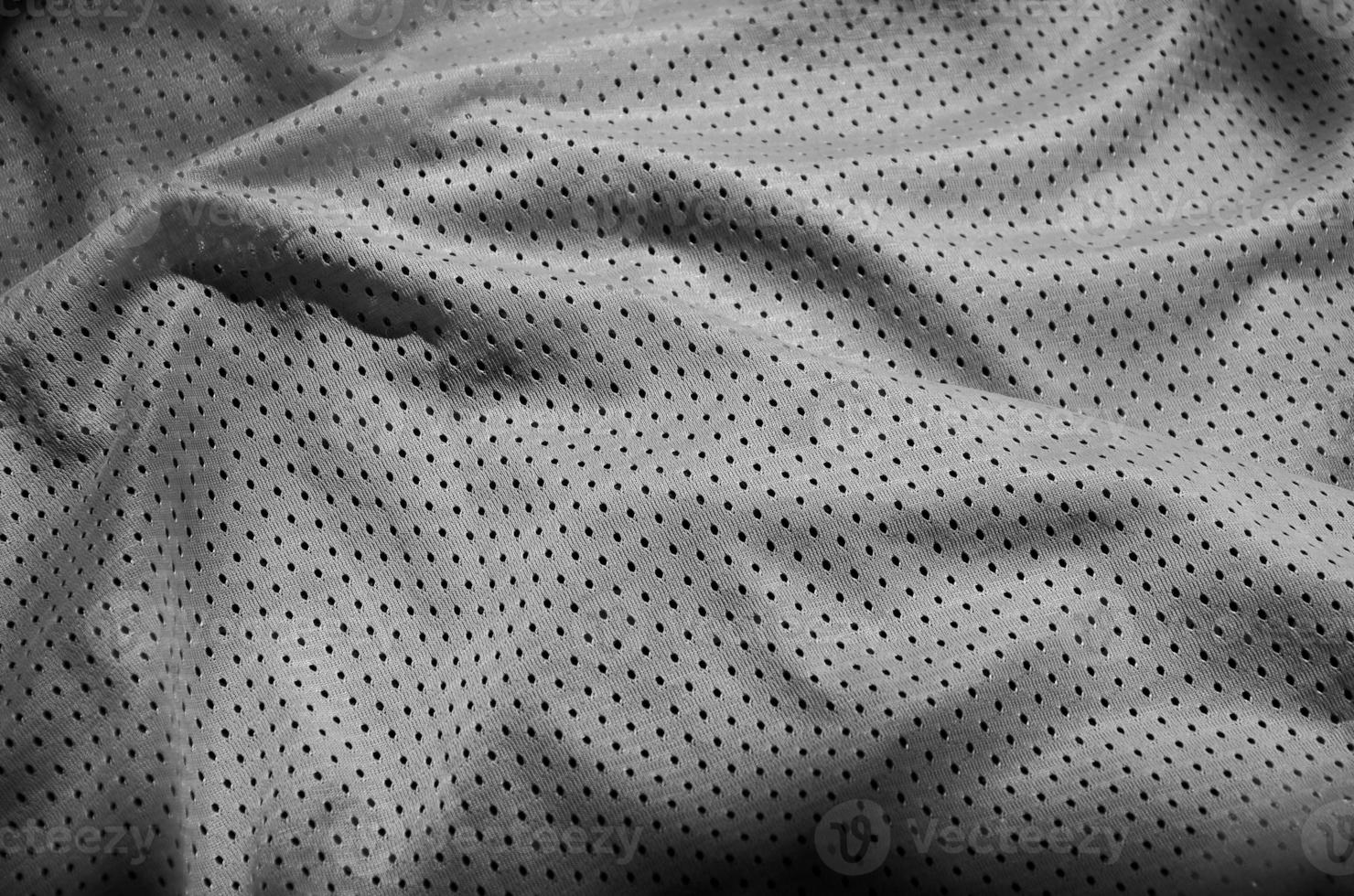 Sport clothing fabric texture background. Top view of grey polyester nylon cloth textile surface. Dark photo