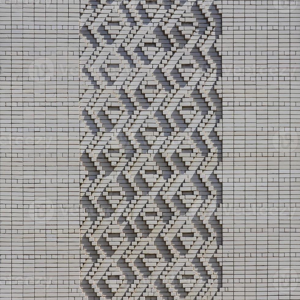 A pattern made of white bricks in the form of diamond shapes. Decoration of the walls during the Soviet Union photo