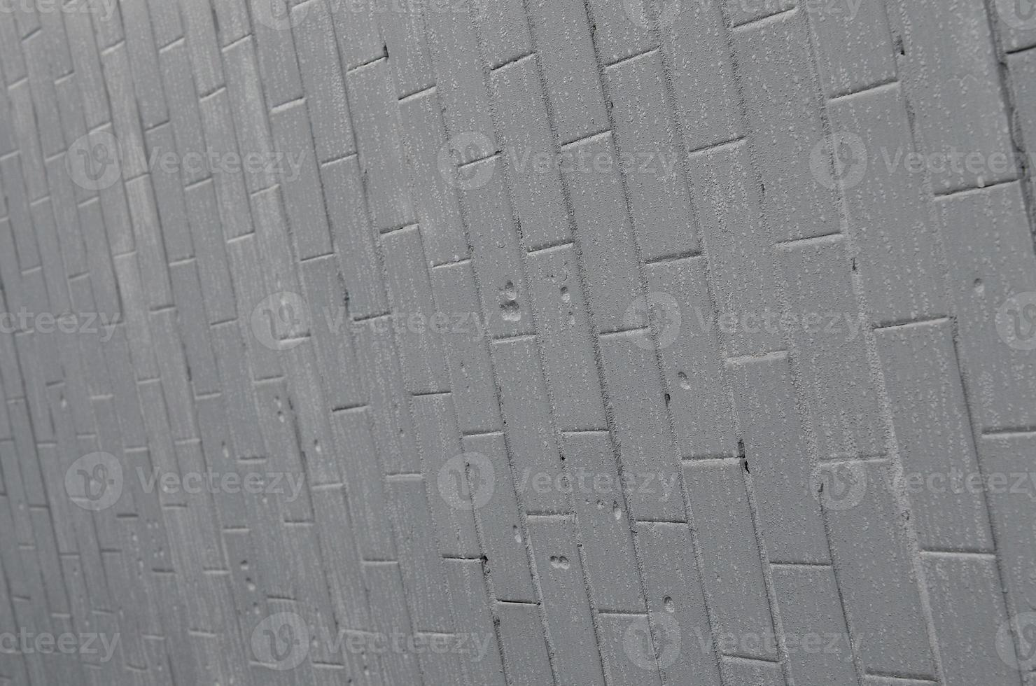 The texture of the wall from the old tile, painted gray under the influence of condensation. A lot of small drops and water stains on the wall photo