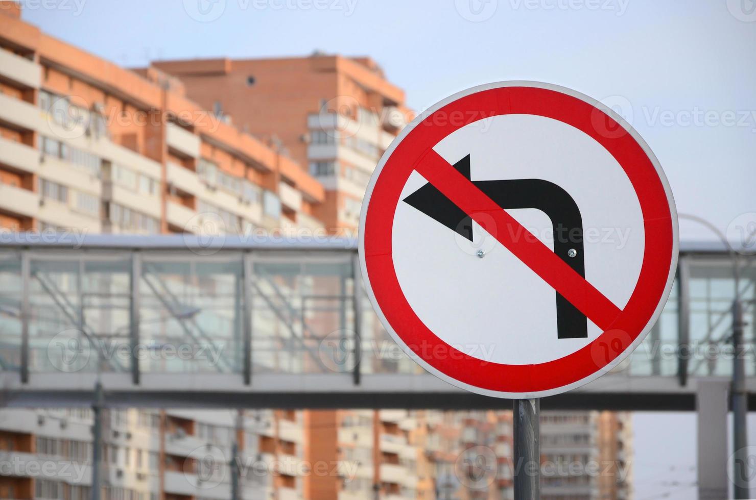 Turn left is prohibited. Traffic sign with crossed out arrow to the left photo