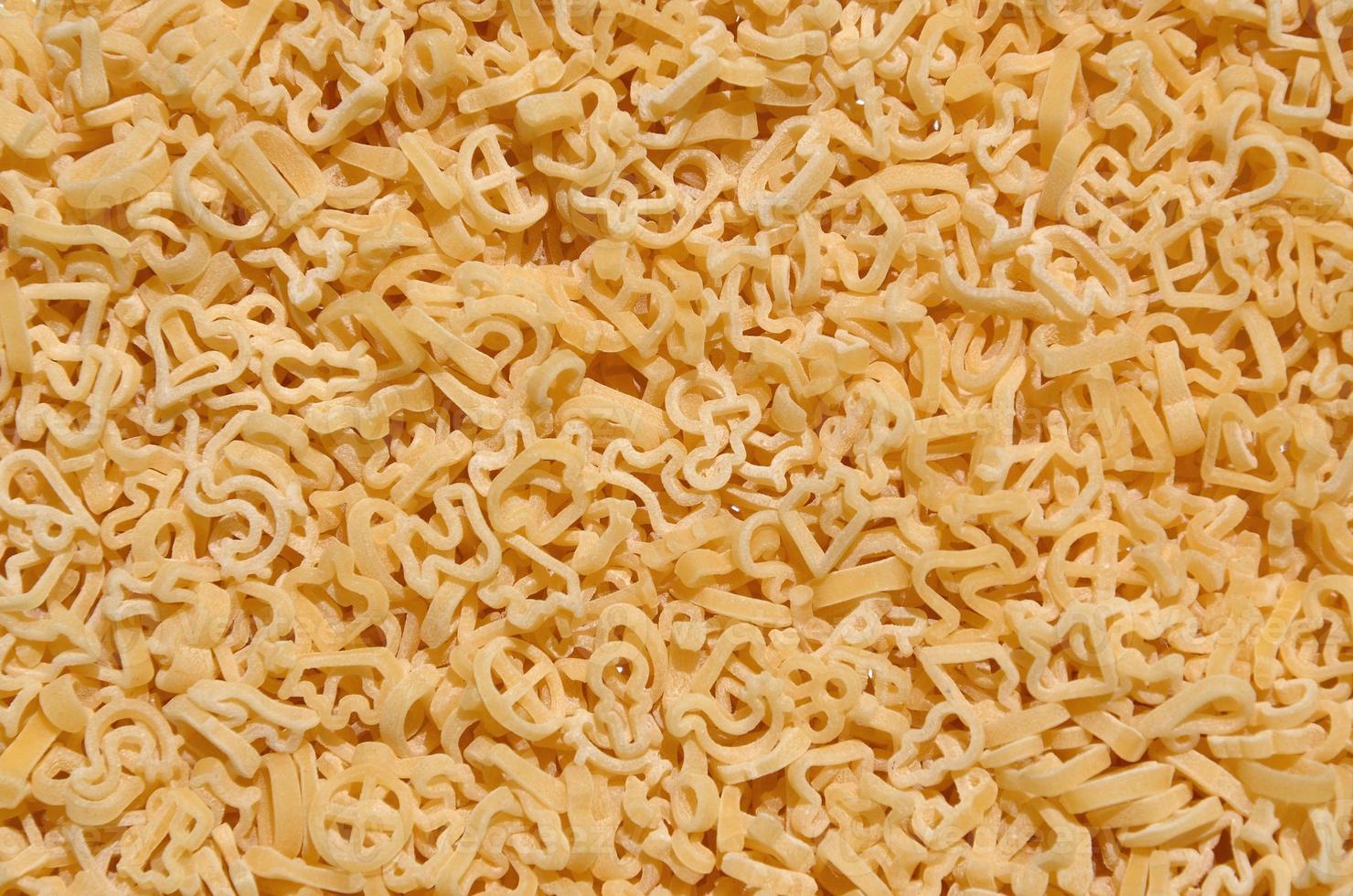 Texture of a lot of curly raw yellow pasta photo