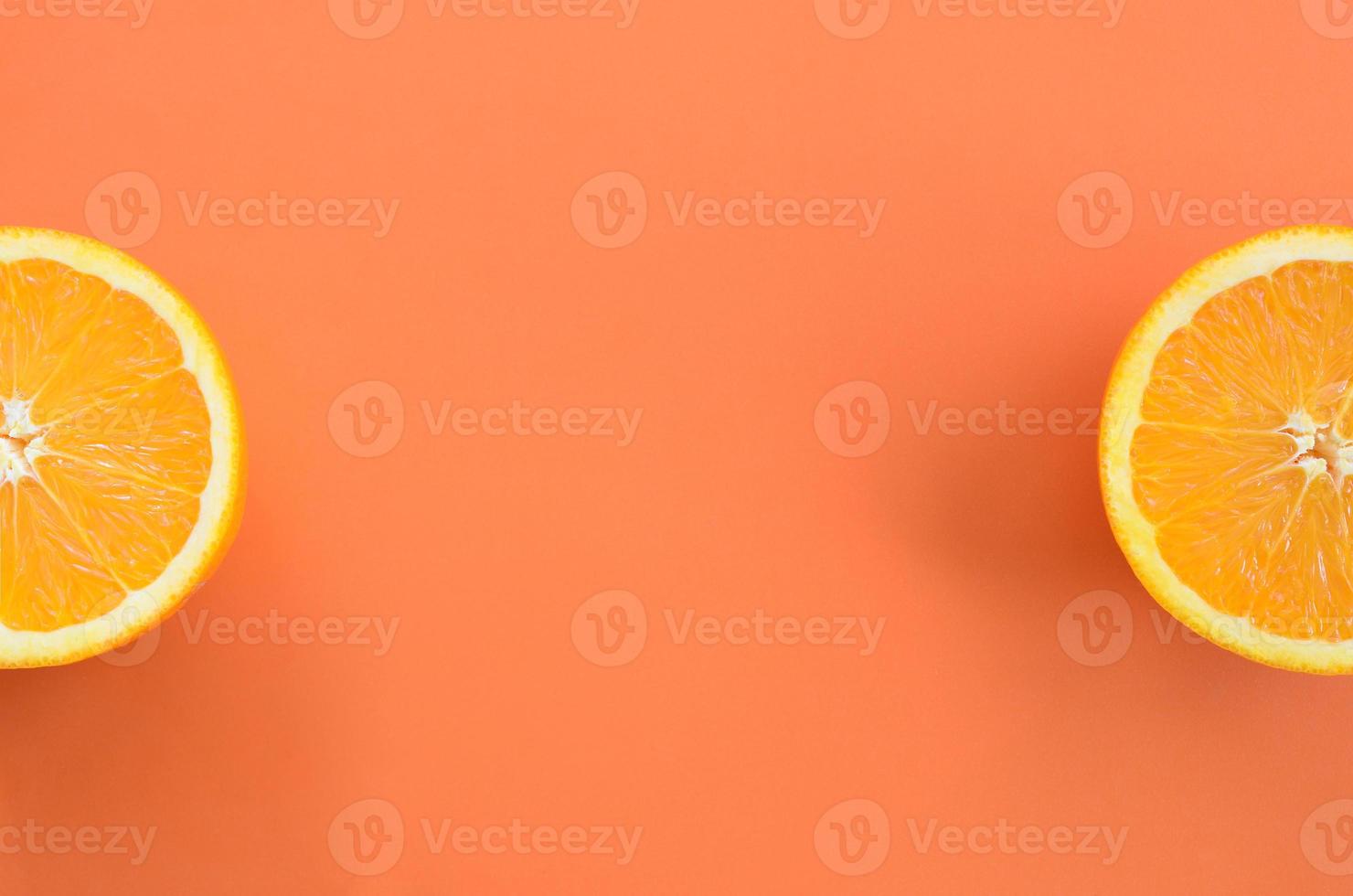 Top view of a several orange fruit slices on bright background in orange color. A saturated citrus texture image photo