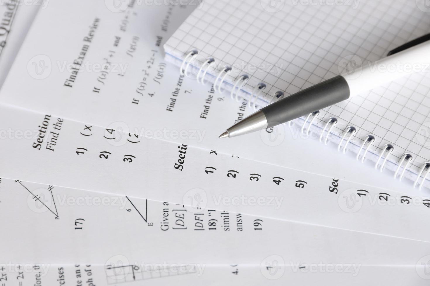Handwriting of mathematics quadratic equation on examination, practice, quiz or test in maths class. Solving exponential equations concept. photo