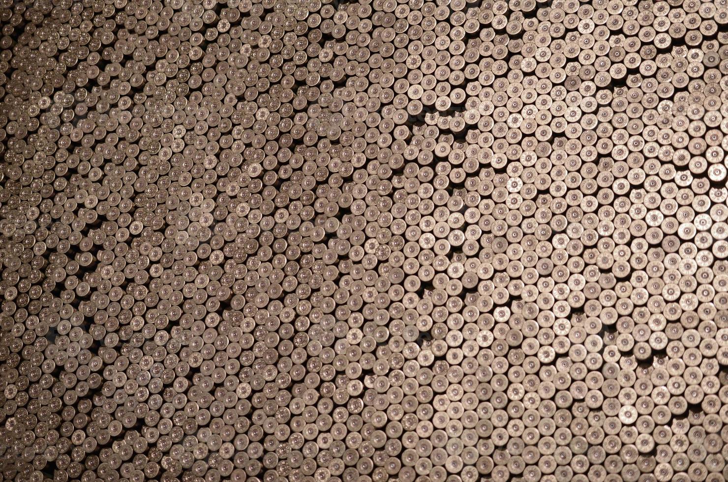 Pattern of 12 gauge cartridges for shotgun bullets. Shells for hunting rifle close up. Backdrop for shooting range or ammunition trade concepts photo