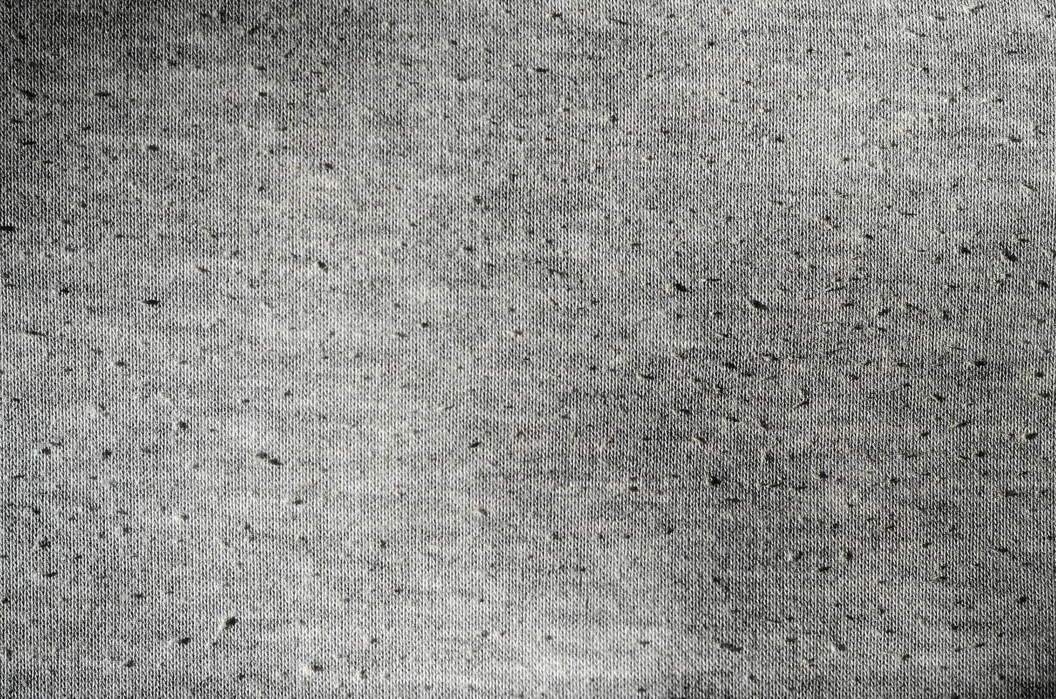 Real heather grey knitted fabric made of synthetic fibres textured background photo