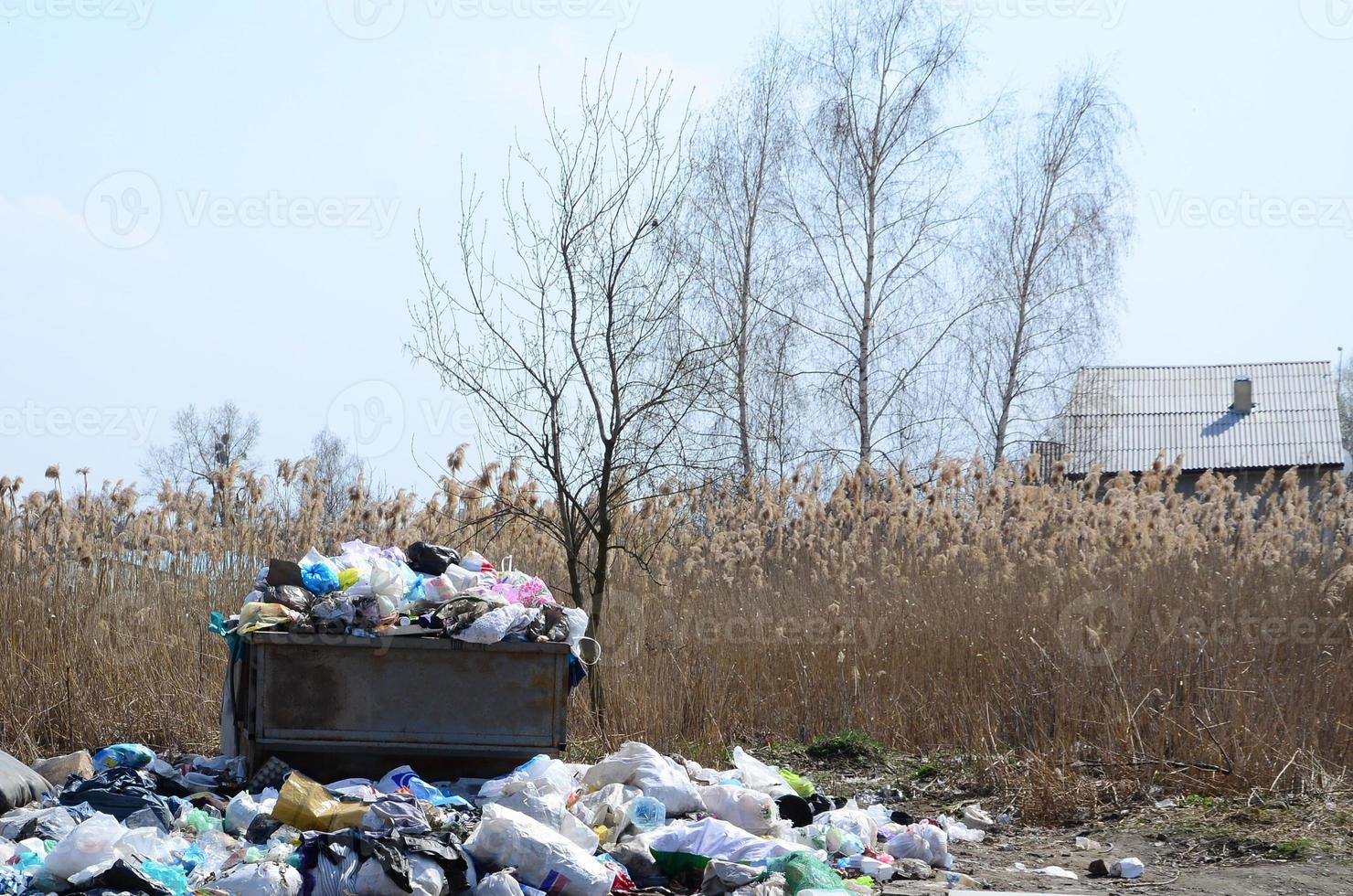 The garbage can is packed with garbage and waste. Untimely removal of garbage in populated areas photo